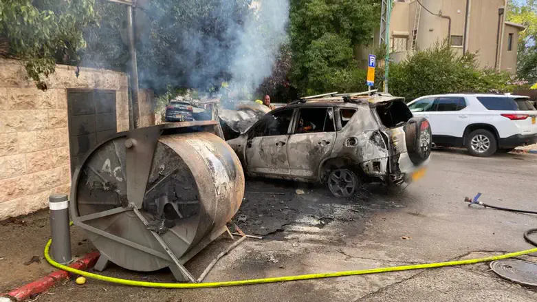 The burned car and garbage bin
