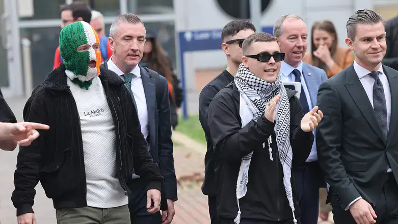 Kneecap members, including singer Liam O'Hanna (C) leaving Woolwich Crown Court, in 2025.