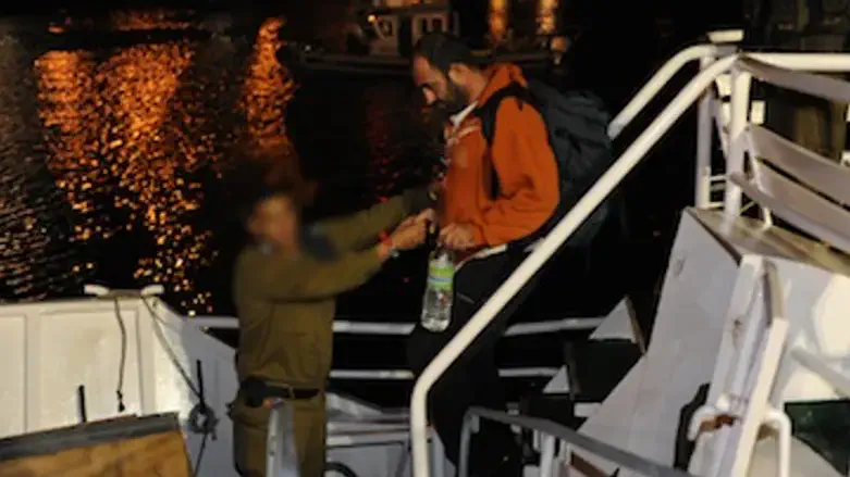 IDF soldier helps flotilla member off ship
