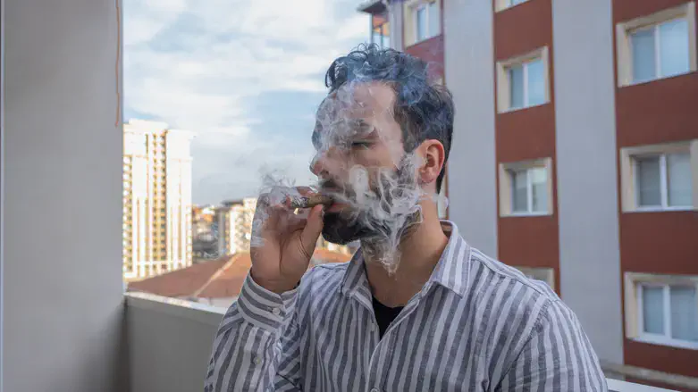Smoking on a balcony in an apartment building (illustrative)
