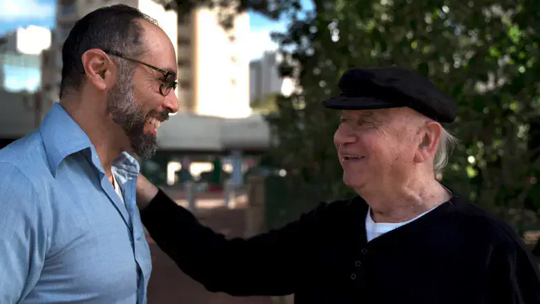 Director Yoav Potash greets Yaacov Goldstein
