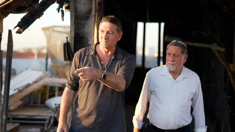 Rabbi Shraga Fruchter on the damaged roof