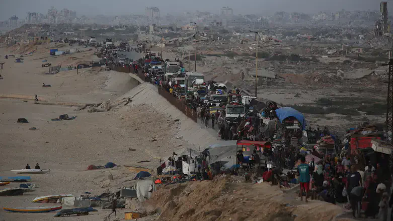 Palestinians flee with their belongings loaded on vehicles and carts