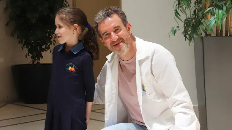 The girl, now recovered, with Dr. Michael Gorvitz