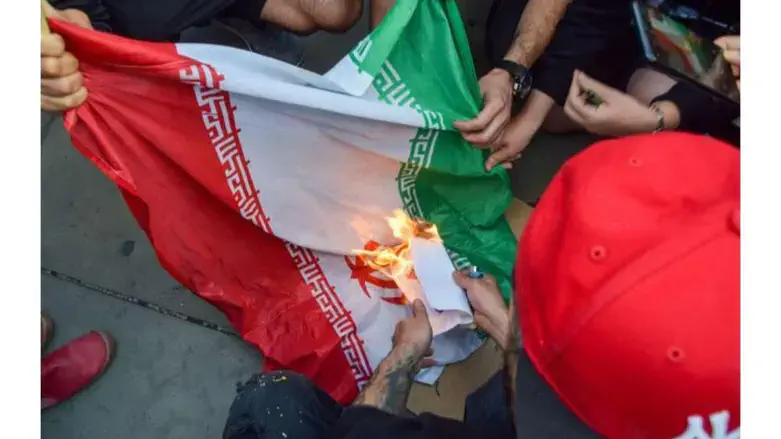 Protesters burn Iranian flag