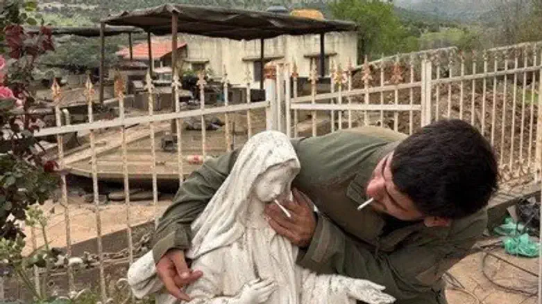 soldier puts cigarrete in statue's mouth