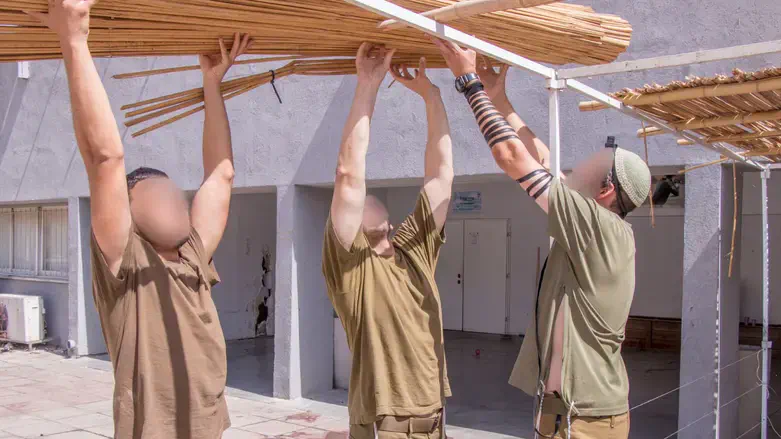 Soldiers build a sukkah