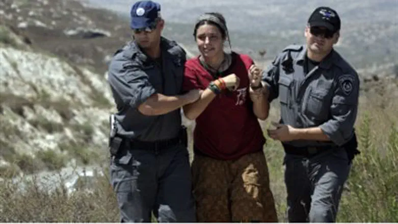 Police manhandle an activist.