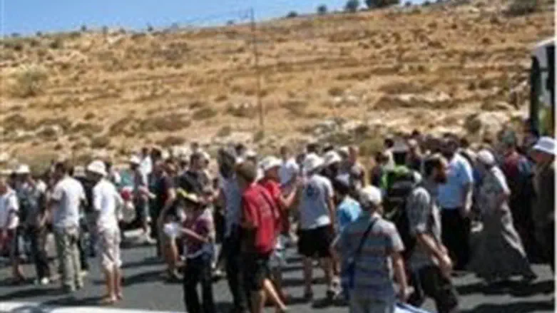 Marchers gather at the scene of the attack