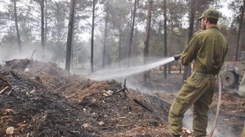 IDF soldier puts out a fire