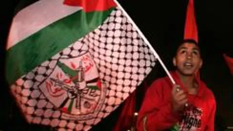 Youth waves PA flag, featuring rifles