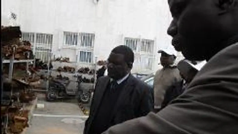 Kenyan delegation examining rocket remains