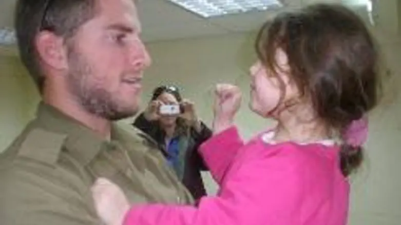 Soldier Encouraging Child in Bombarded City
