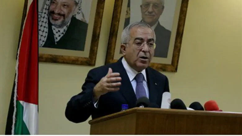 Fayyad, with Arafat on wall