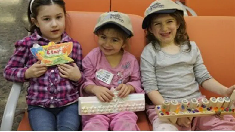 Three young olim prepare for Chanukah