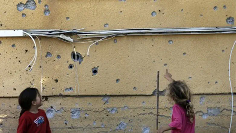 Children look at rocket damage