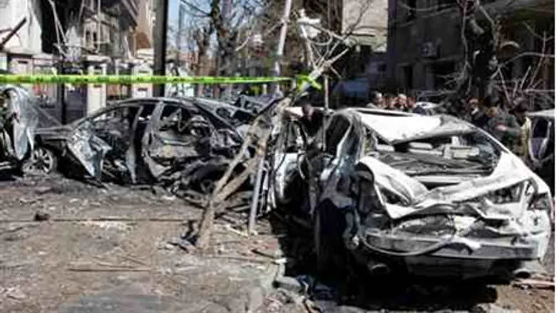 Damaged vehicles at the site after two explos