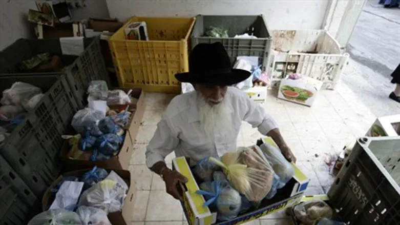 Volunteer prepares food packages