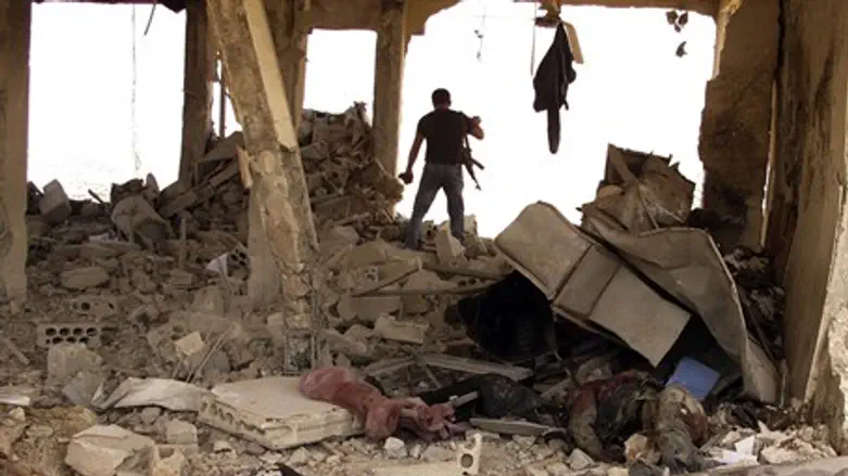 A member of the Syrian free army walks past b