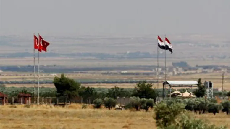 Turkish and Syrian flags are seen on the Turk