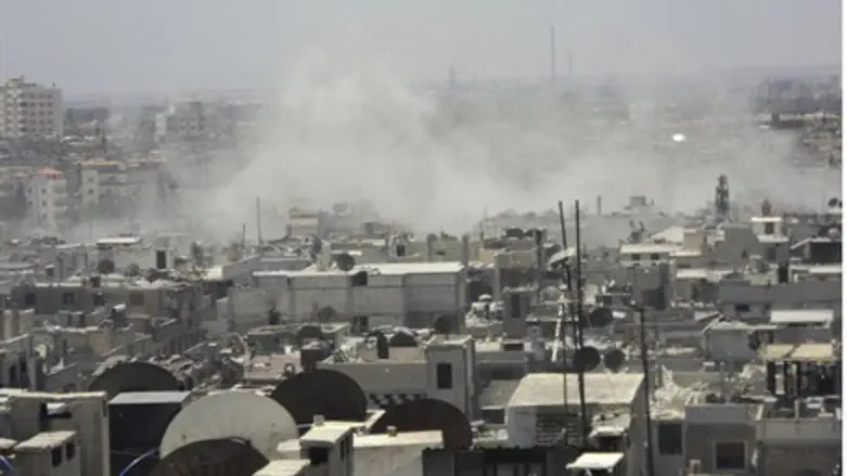 Smoke rises from village enear Homs