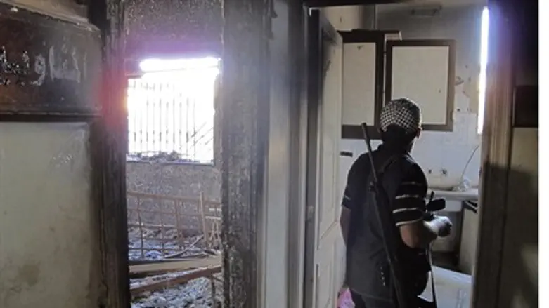 FSA soldier checks building in Aleppo provinc