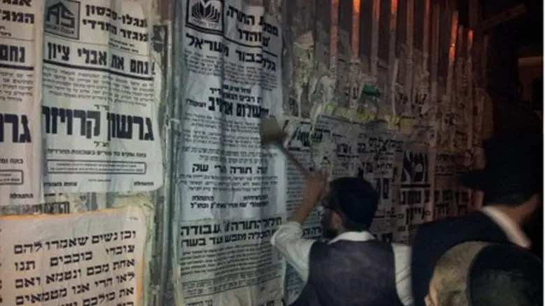 Putting up notice of Rabbi's passing.