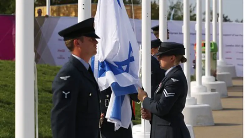 The flag of Israel is raised during a welcomi