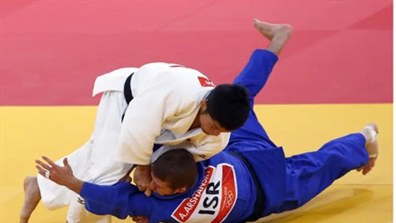 Japan's Hiroaki Hiraoka fights with Israel's