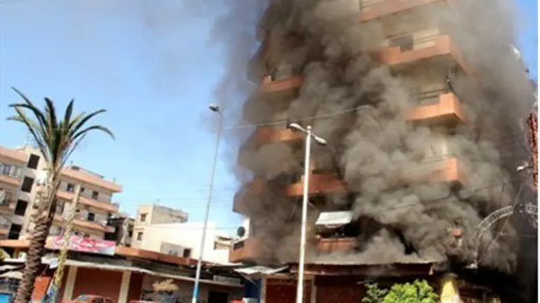 Smoke rises from Sunni Muslim dominant neigh