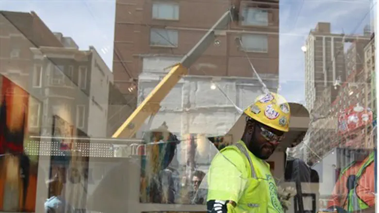 Construction workers clean up an art gallery