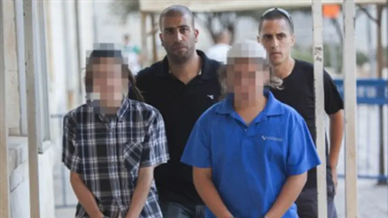 Two of the suspects in handcuffs