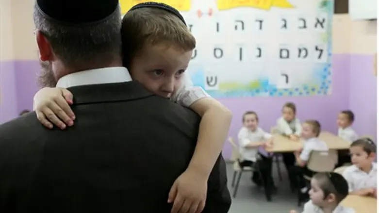 Boy being comforted by teacher
