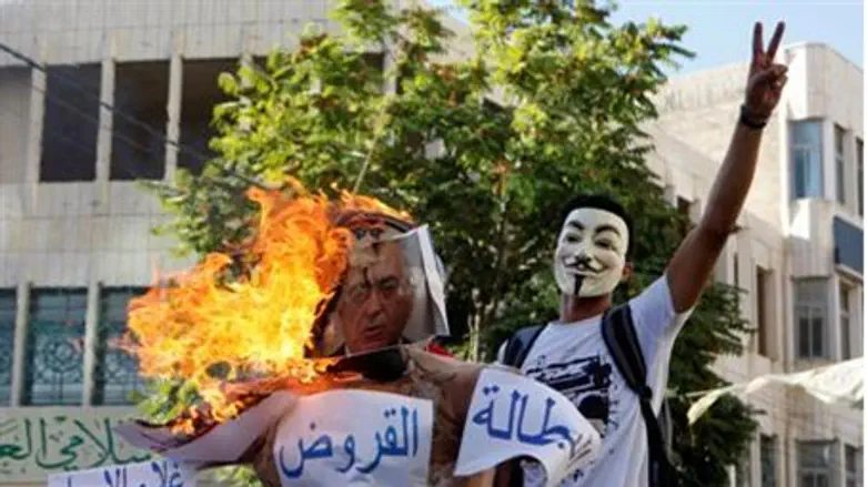 Arab protester wearing a Guy Fawkes mask ne