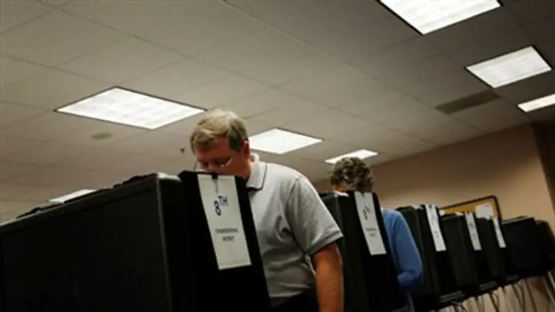Voters cast ballots on touch-screen voting m