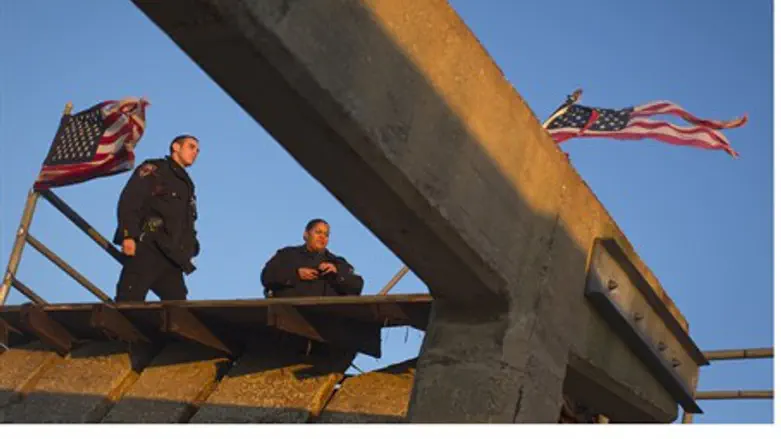 NYPD police officers stand on devastated Rock