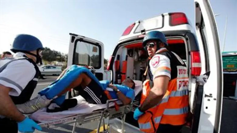 Medics transport a wounded man after a rocket