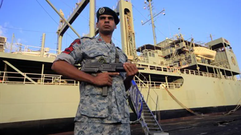 An Iranian soldier stands guard near Iranian 
