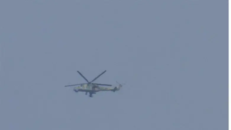 Syrian Army helicopter flies over Houla, near