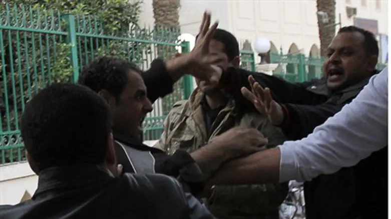 Morsi supporters fight with an anti-Morsi pro