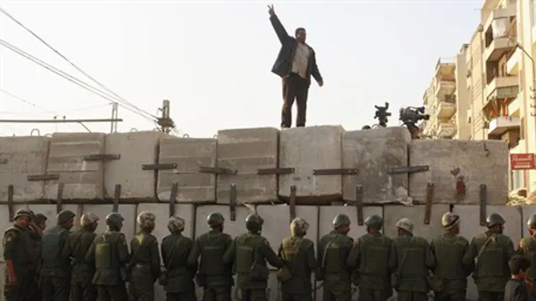 An anti-Morsi protester chants slogans outsid