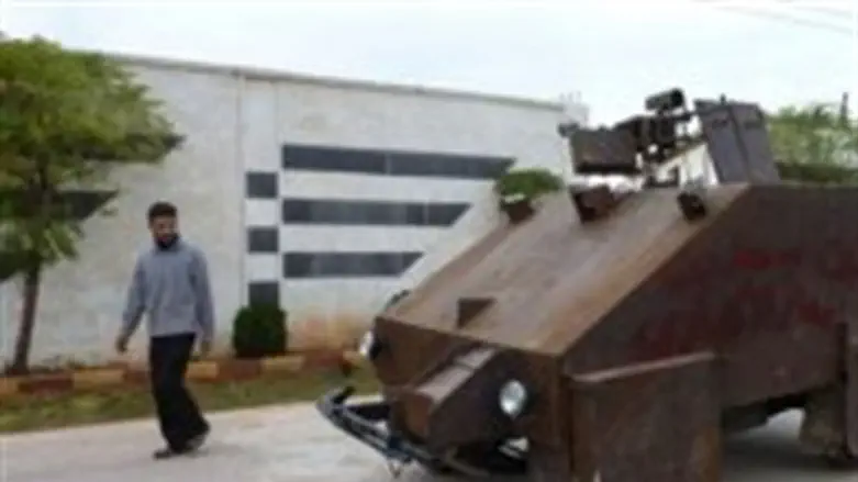 A Syrian rebel walks past Sham II