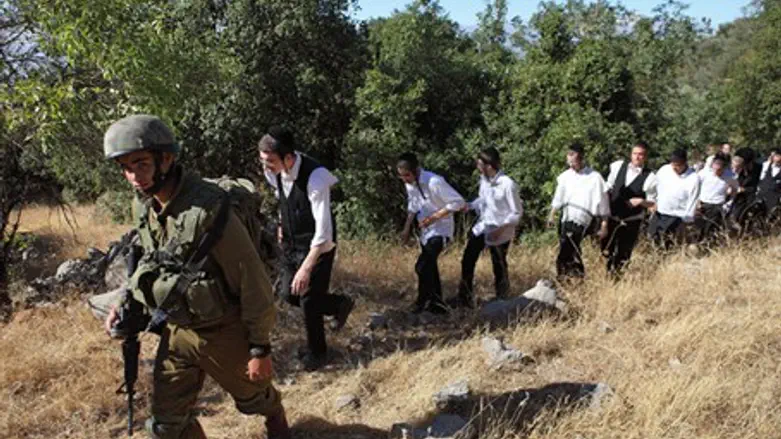 An Israeli soldier escorts ultra-Orthodox Jew