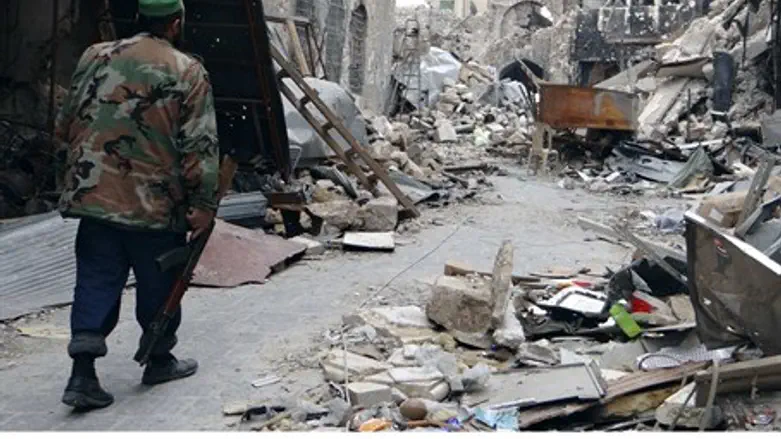 A Free Syrian Army fighter walks along a dama