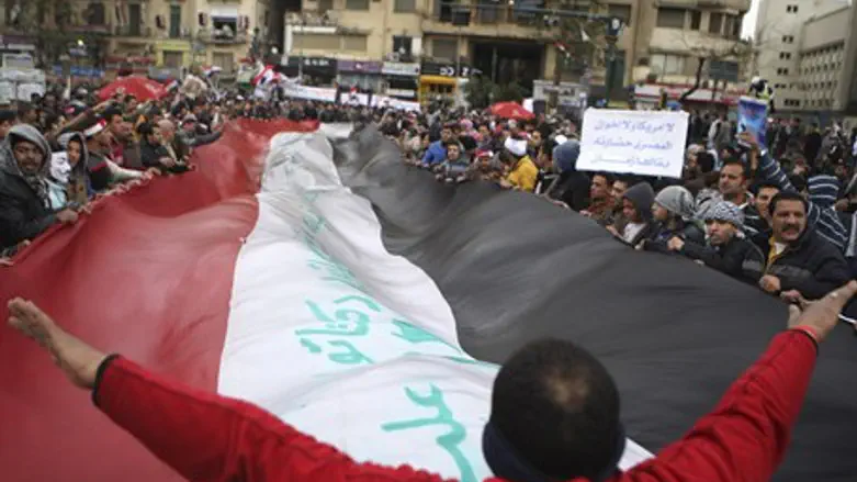 Anti-Morsi demonstrator gestures to a crowd o