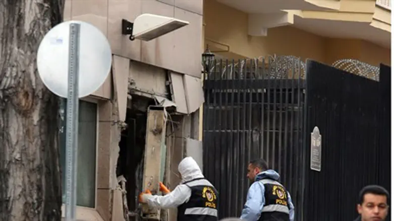 Bomb experts inspect the site of an explosion