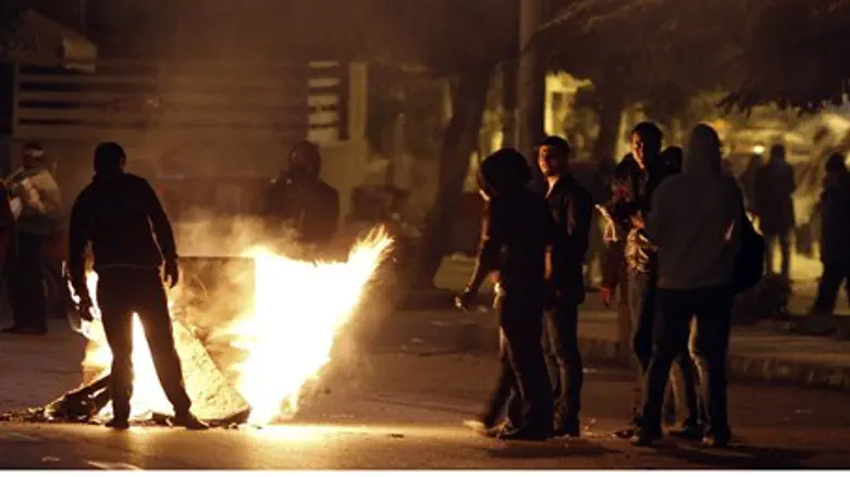Anti-Morsi protesters during clashes with pol
