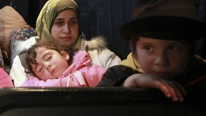 Syrian refugees rest in Jordanian army bus