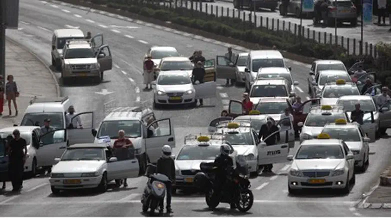 Israelis stand next to their vehicles as the