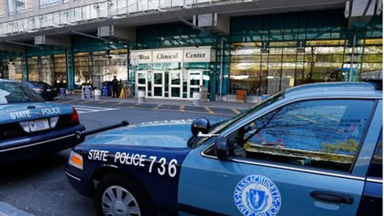 Police stand guard outside the hospital in wh